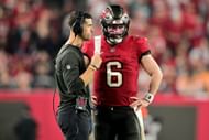 Dave Canales is giving Baker Mayfield some instructions.